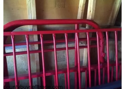 Red metal bunk bed frame.