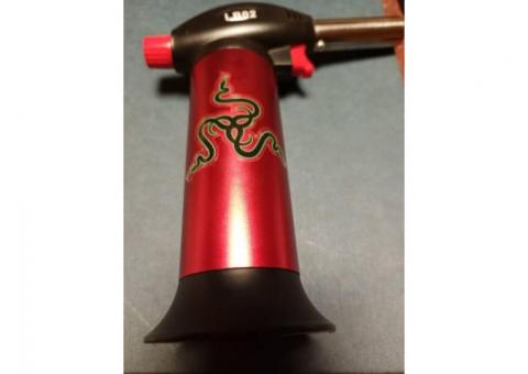 Red Blink refillable, adjustable Butane Torch in like new condition.